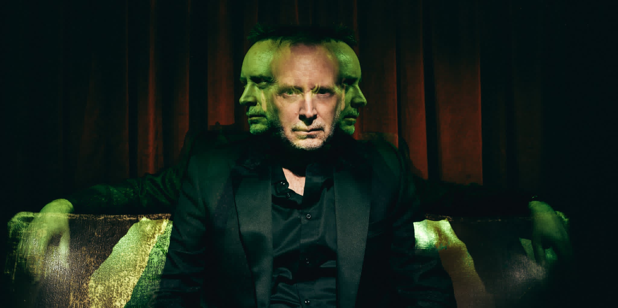 Kevin Kopfstein lit in eerie green and crimson light for HAUNTED, a ghost stories and magic show every Thursday at The Lost Dice, Adelaide.